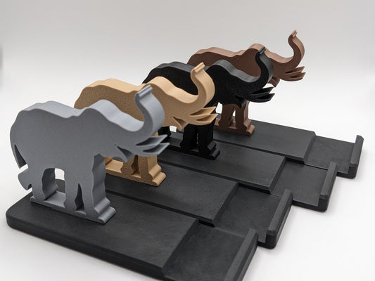 A collection of elephant phone holders in a variety of colours