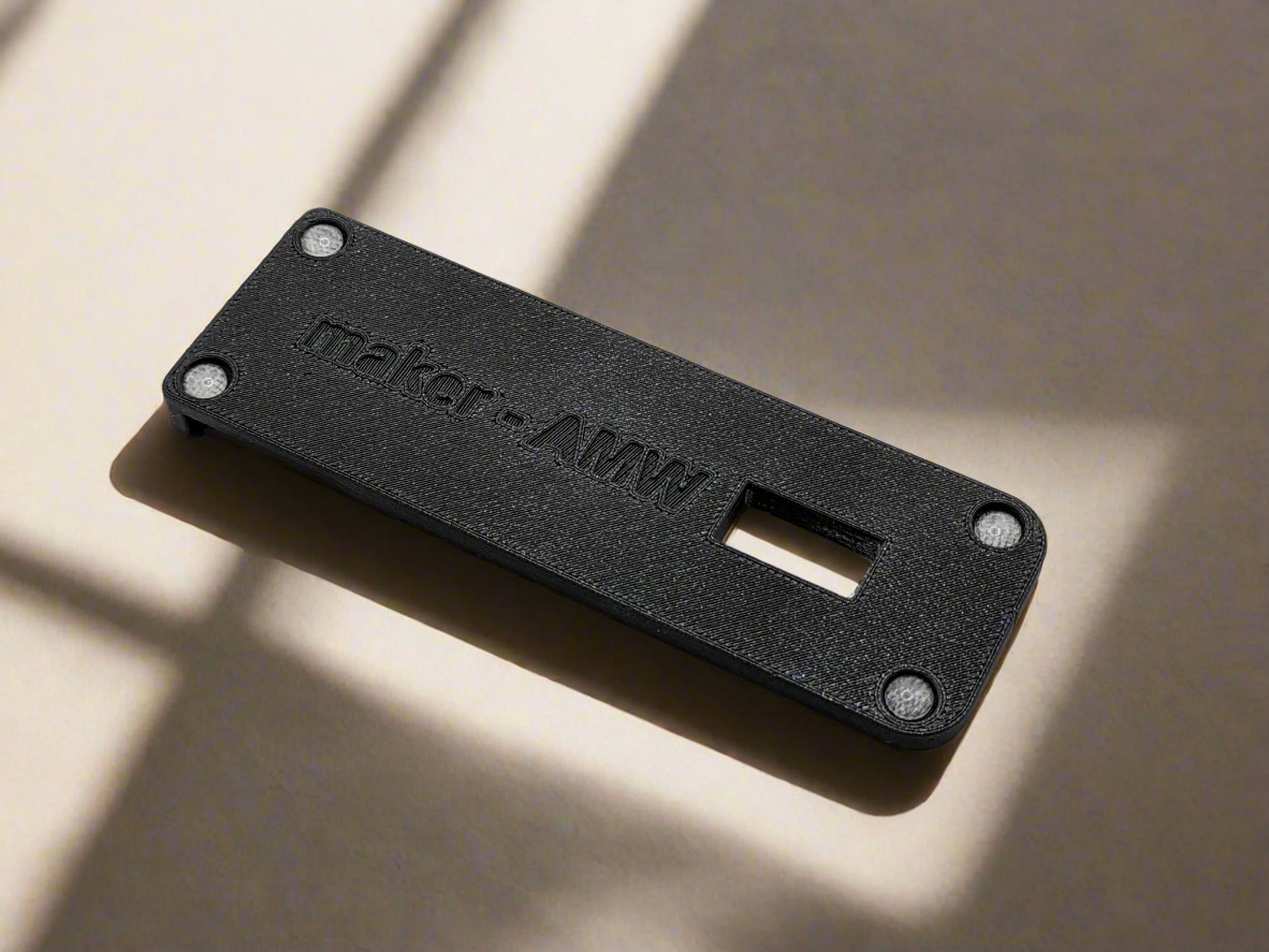 The underside of a base of a maker-AMW phone holder.